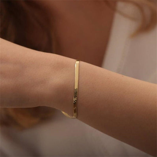 18k gold herringbone bracelet, hypo-allergenic, water proof, sweat proof, and tarnish free. Made for everyday wear.